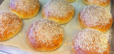 a pan of golden sesame burger buns
