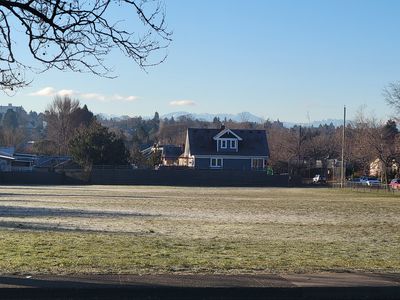 frosty grass and long shadows in Shakespeare Park, with mountains in the distance