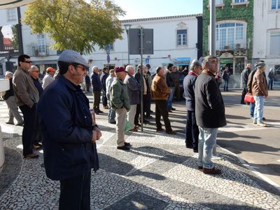 several dozen men watching the truck parade.