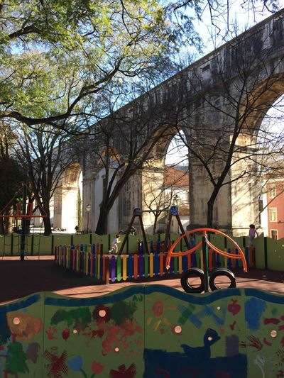 children's playground under an aqueduct