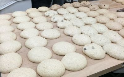 a bench full of round loaves ready to be shaped