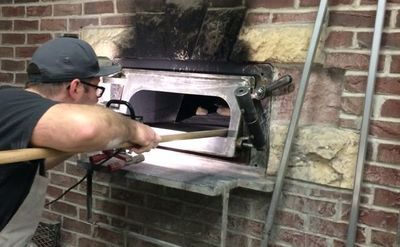 Bryn loading the brick oven