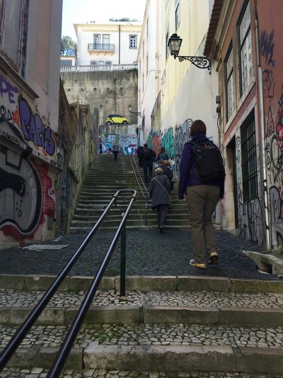 view walking up an extremely steep sidewalk staircase in Lisbon