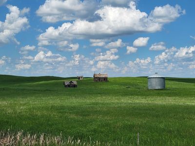 abandoned grain elevators in a field