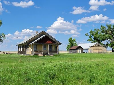 abandoned farmhouse and outbuildings