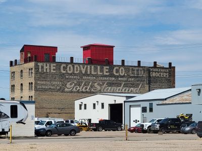 faded sign on side of building in Moose Jaw