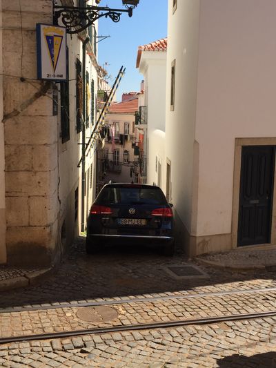 a car wedged in a tight alley
