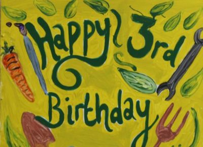 Hand painted sign saying Happy 3rd Birthday