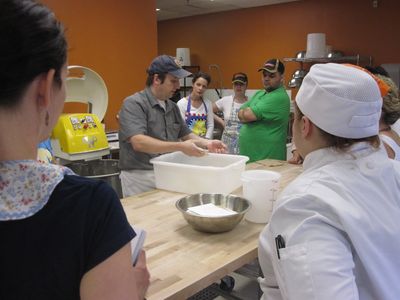Mark demonstrates hand mixing dough